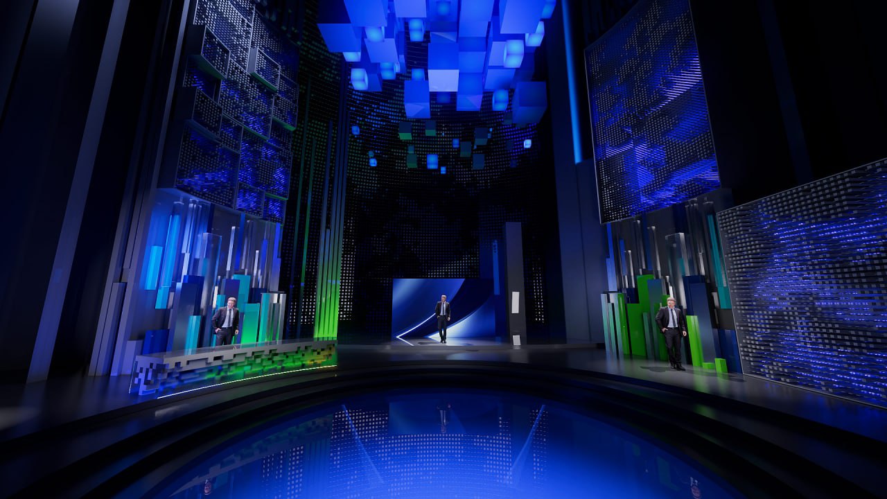 Tall blue-green atrium-like studio volume with luminous ceiling cubes and multiple presenter points.